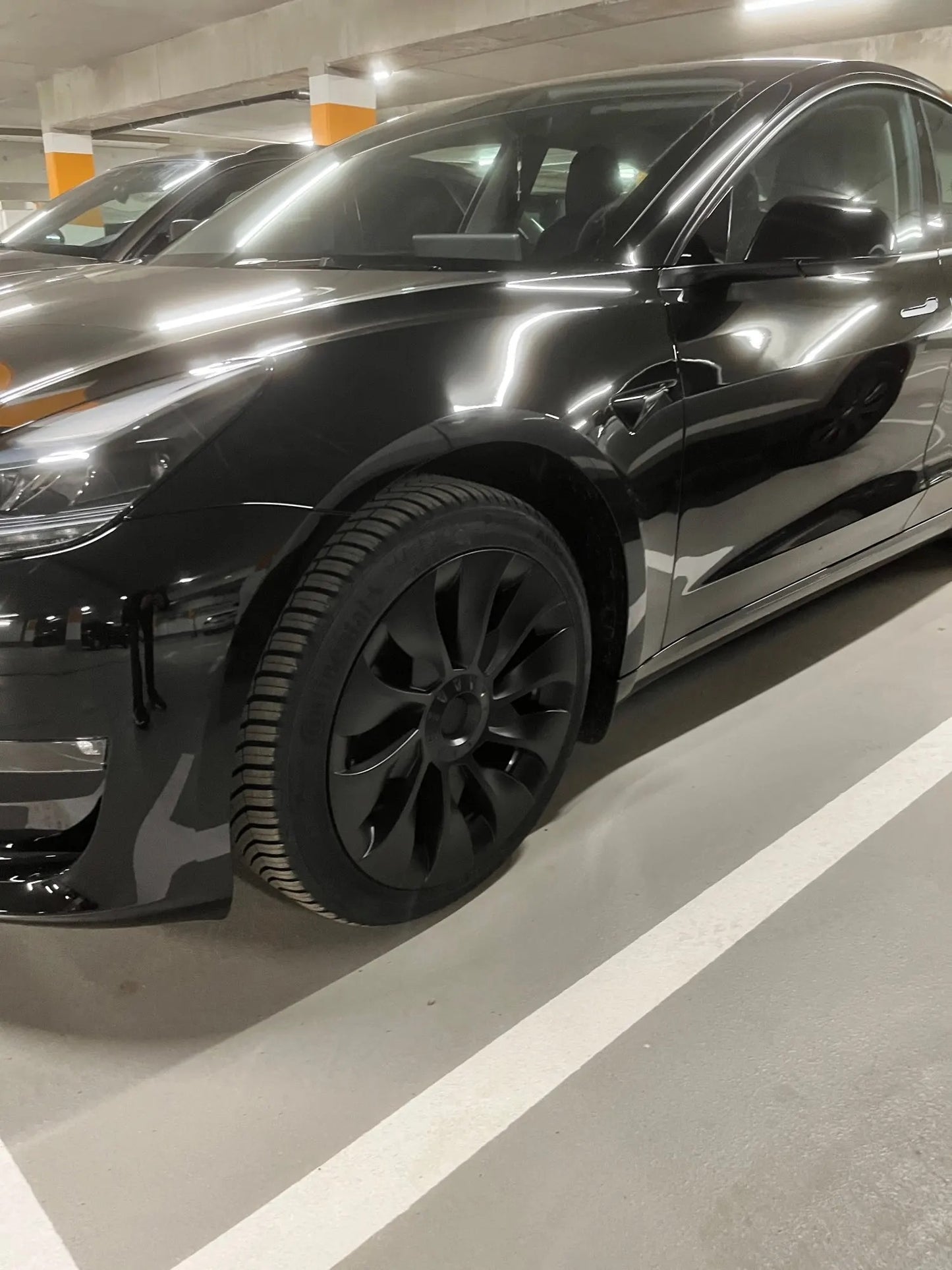 Tesla Model 3 met zwarte Performance Turbine wieldoppen set voor een sportieve look, inclusief klemmen, naafkapafdekkingen en afdichtband