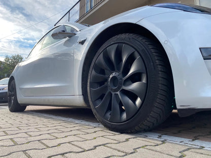 Tesla Model 3 met zwarte Performance Turbine wieldoppen set voor een sportieve look, inclusief klemmen, naafkapafdekkingen en afdichtband