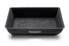 Detailfoto van de stoffen afwerking van de Tesla Model Y organizers voor onder de stoel, die geluiden tijdens het rijden dempt.