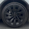 Close-up van een gemonteerde wieldop Tesla Model Y Juniper 2025+ Helix 20 inch zwart met matte afwerking op een Michelin Pilot Sport 4-band.
