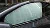 Zonnescherm op het zijraam van een Tesla Model Y met zilveren reflectielaag tegen zonlicht en oververhitting van het interieur.